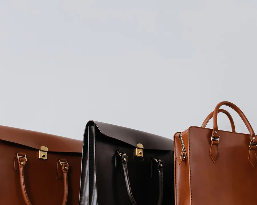 Finished hand-stitched leather bags standing side by side