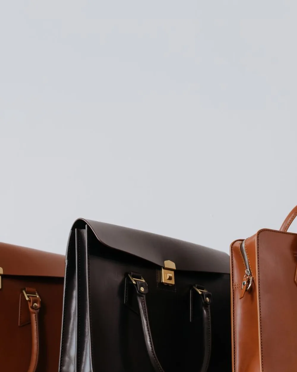 Finished leather bags lined up ready for the studio shop floor