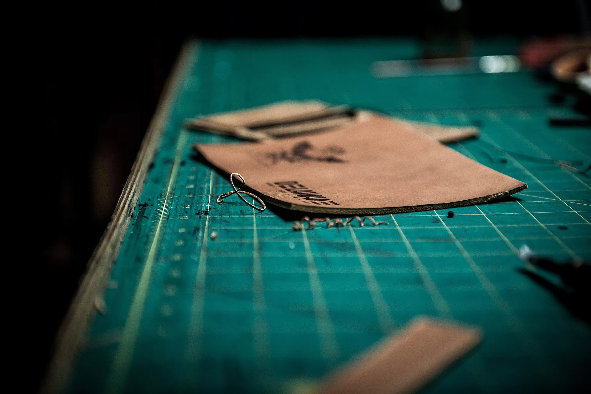 Leather being cut to pattern on the bench in the Bali Leathercraft Studio workroom