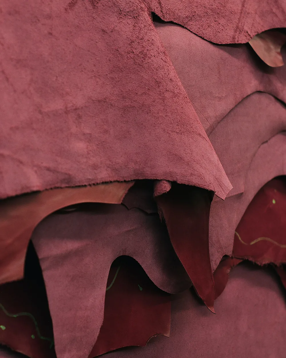 A stack of tanned hides ready to be cut for a production run