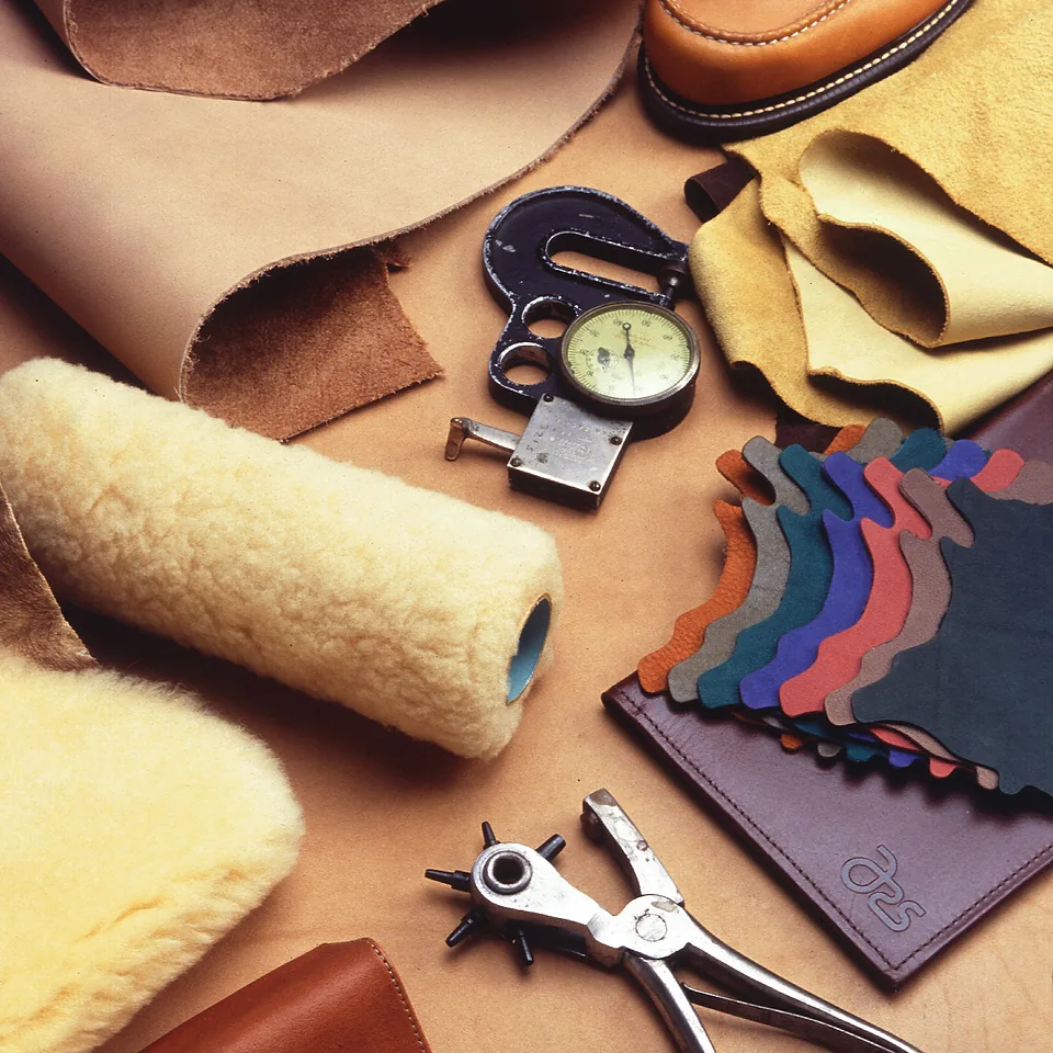 Leathercraft hand tools and hide swatches on the bench