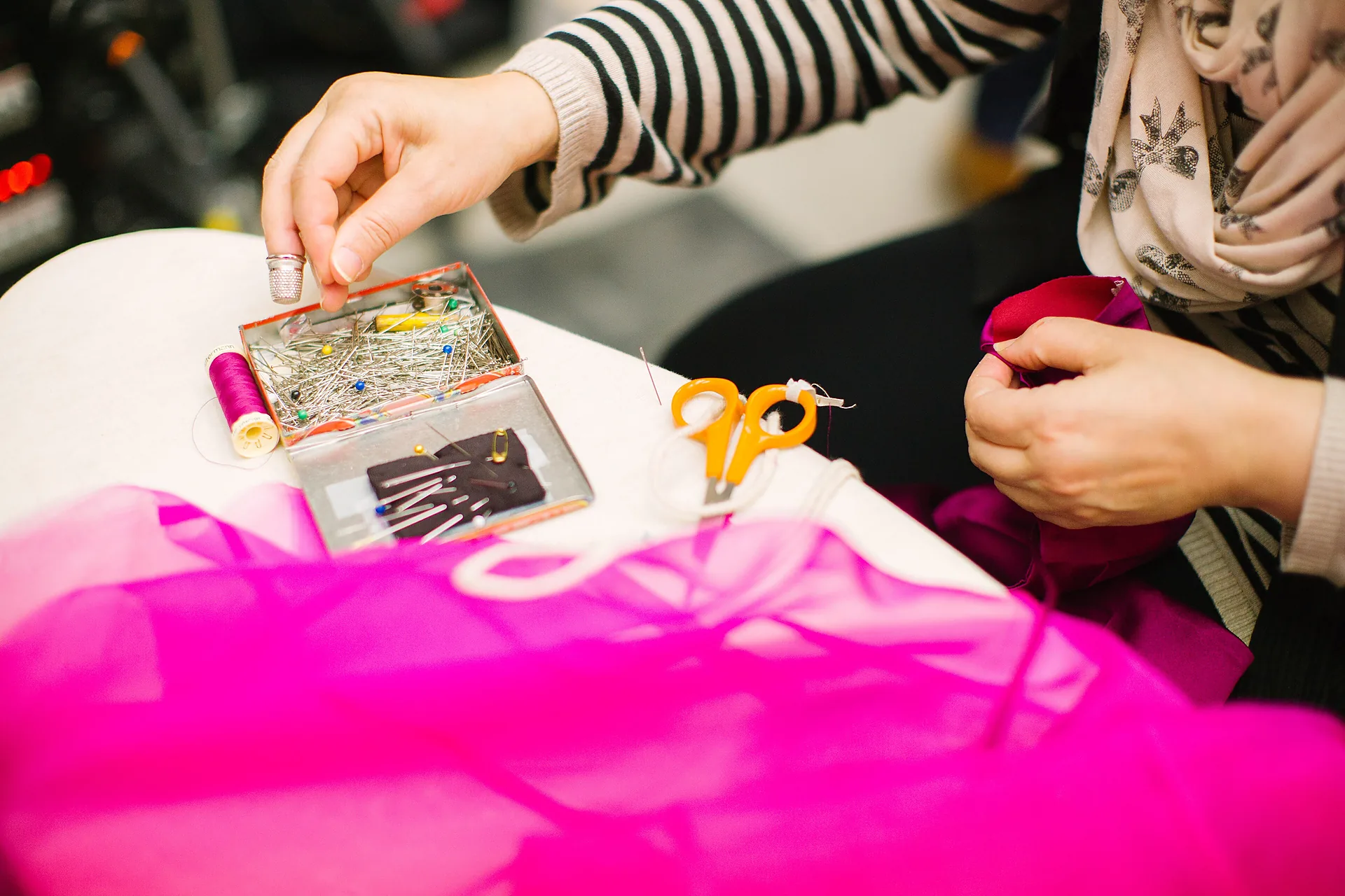 Students working side by side at a craft workshop table