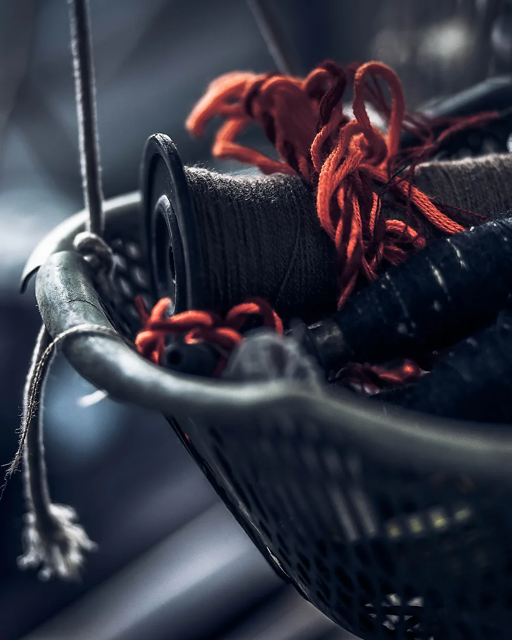A basket of waxed saddle-stitching thread in a leather workroom