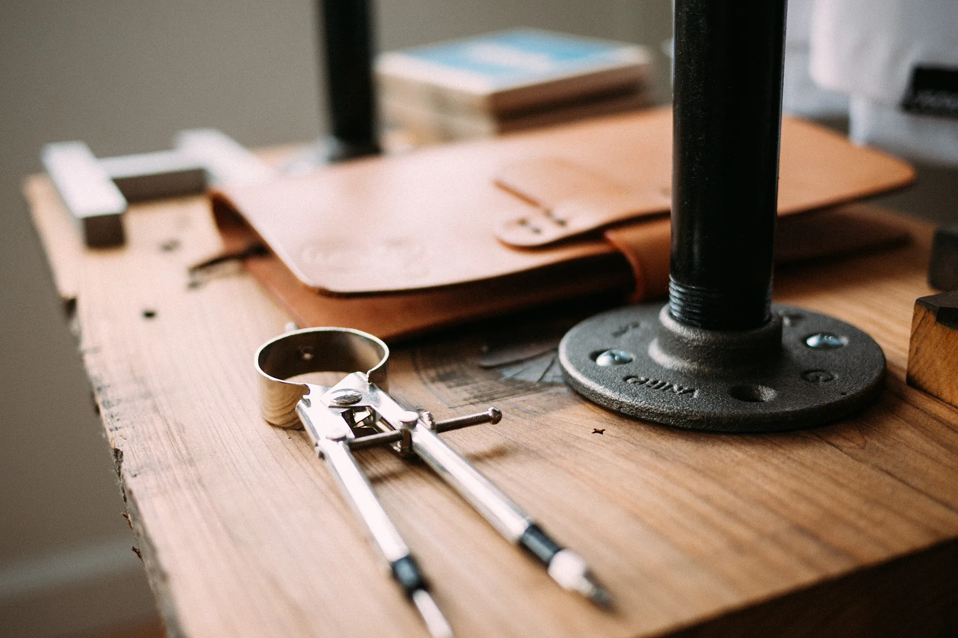 A private workbench set with leather, dividers and hand tools before a session