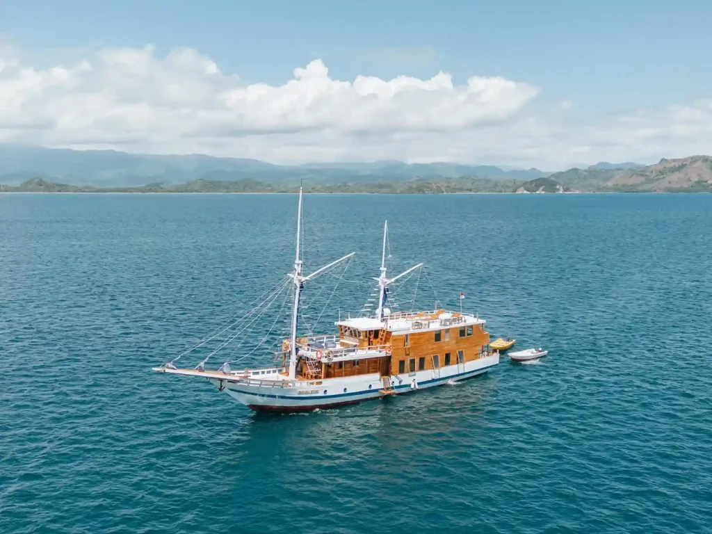 Traditional phinisi sailing yacht anchored in Raja Ampat waters