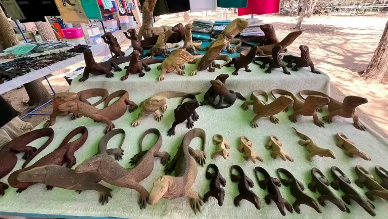 Hand-carved Komodo dragon figurines at a craft stall