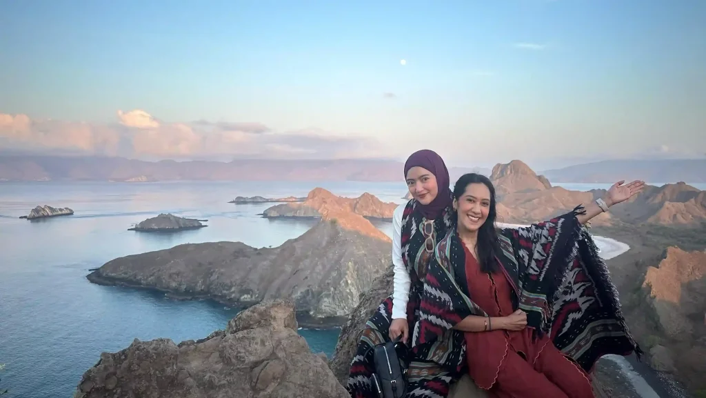 Travellers wearing handwoven songke cloth at a Flores viewpoint